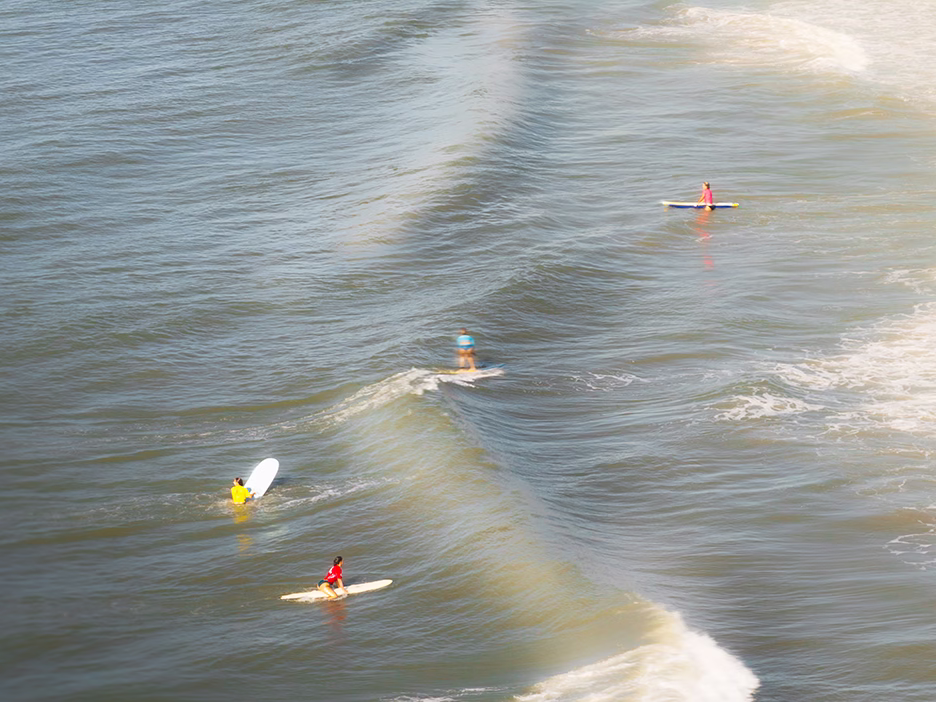 four-surfers-ocean-waves-surfboards.jpg