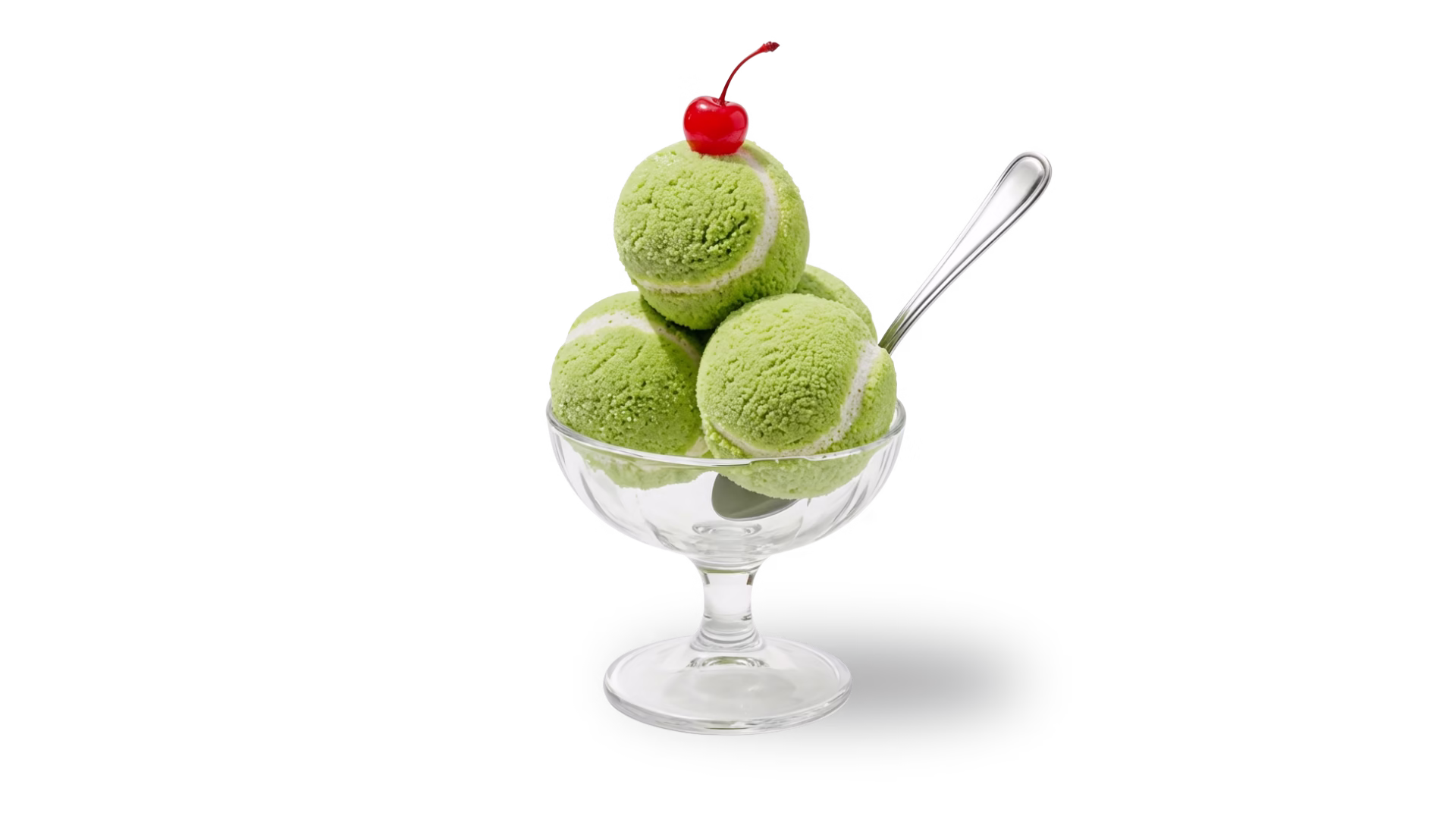 Glass dessert bowl holding three scoops of green ice cream topped with a cherry, isolated on a black background.
